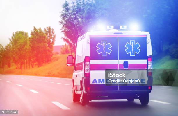 Ambulance Van On Highway With Flashing Lights Stock Photo - Download Image Now - Ambulance, Illuminated, Accidents and Disasters