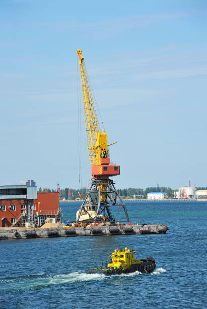 istock Tugboat and port cargo crane 911808846