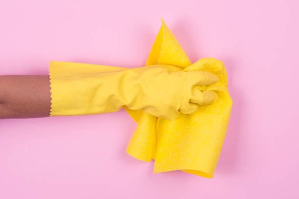 istock Hand in yellow protective glove cleaning with rag 911809028