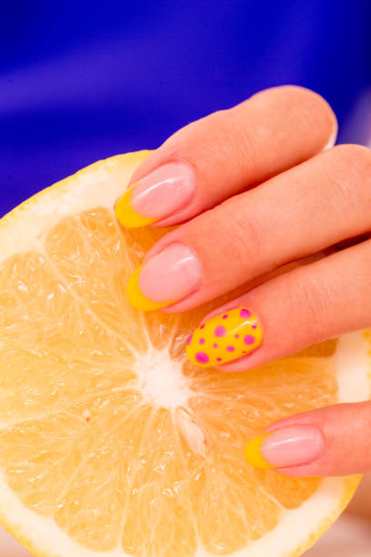 istock Polished Fingernails Holding an Orange 911811538