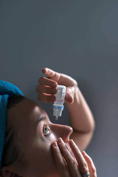 istock Eyedropper releasing fluid into an eye 911811908