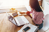 Young woman at home planning family budget and finances.