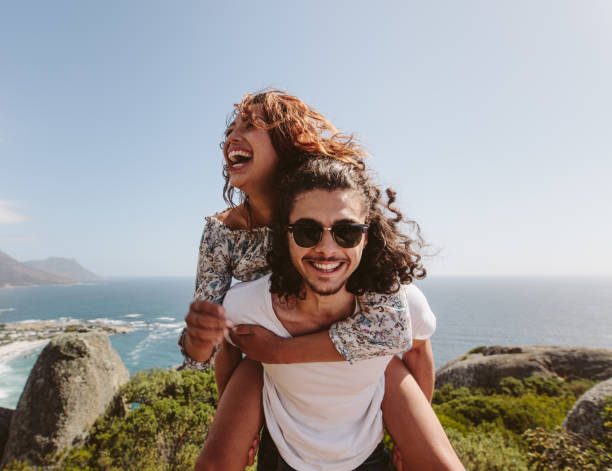 istock Man giving piggyback ride to his girlfriend 911812316