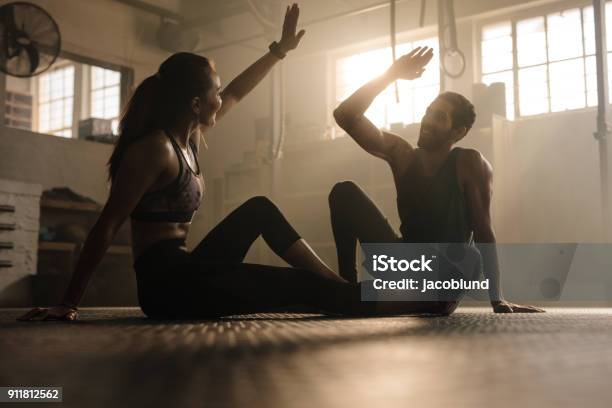 Fit Couple High Five After Workout In Health Club Stock Photo - Download Image Now - Gym, Health Club, Coach