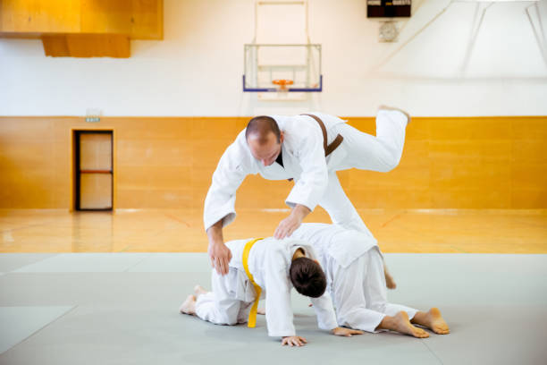 istock Two Judoist Instructor Jumping Over The Judo Student 911812886