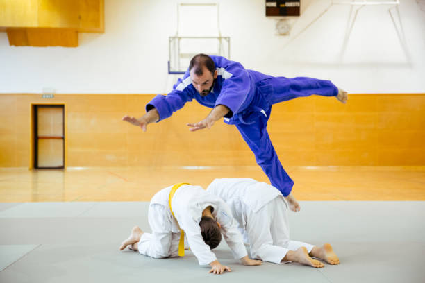istock Two Judoist Instructor Jumping Over The Judo Student 911812896