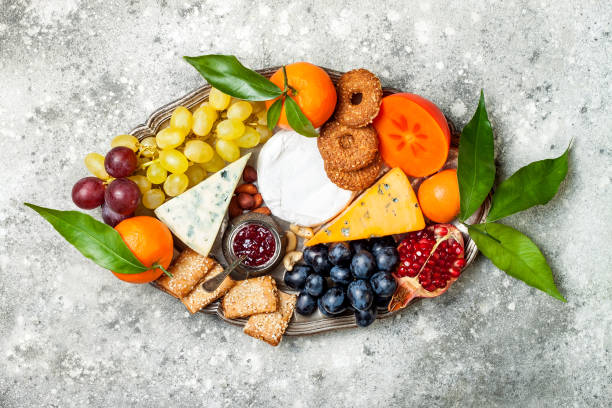 istock Appetizers table with antipasti snacks. Cheese variety board over grey concrete background. Top view, flat lay 911813708