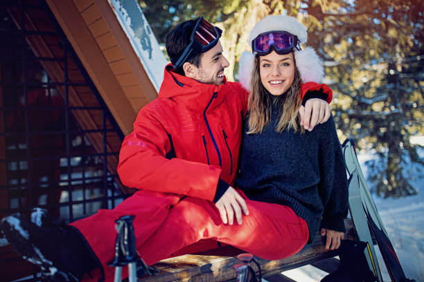 istock Young couple is hugging and resting after skiing 911813954