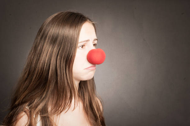 istock young woman with a clown nose 911824304