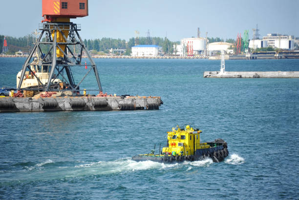 istock Tugboat and port cargo crane 911828414