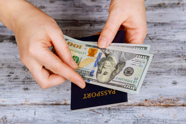 istock preparation for vacation, passport with money for rest on the table 911830726