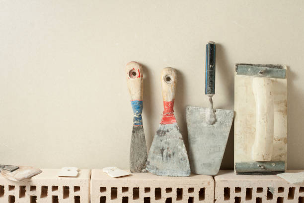 construction tools in a row and bricks.building and renovation concept. - plasterer plaster wall dirty imagens e fotografias de stock