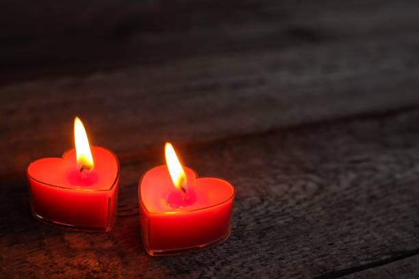 istock Heart shaped candles burning 911833602