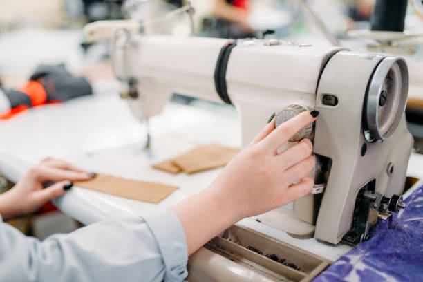 istock Dressmaker hands sews fabrics on a sewing machine 911834244