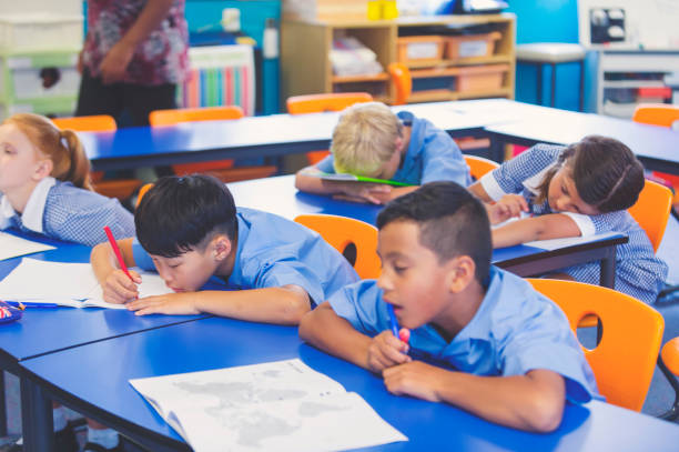 istock School children bored and tired in class. 911839528
