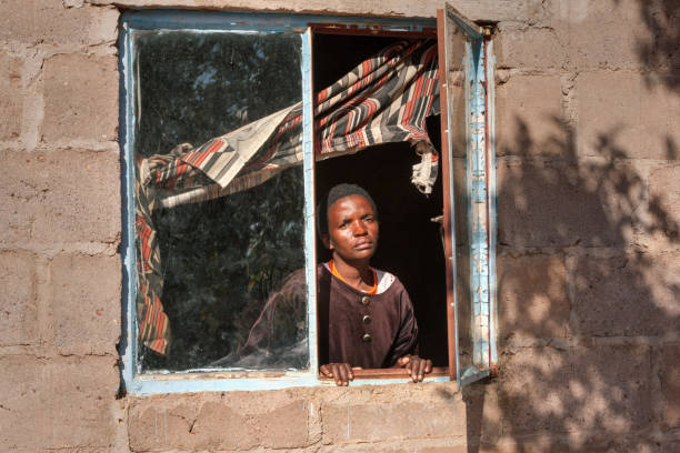 istock African woman in the window 911840030