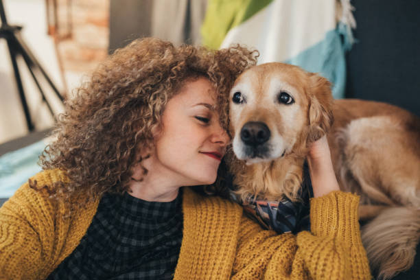 istock Woman cuddling with her dog 911843876