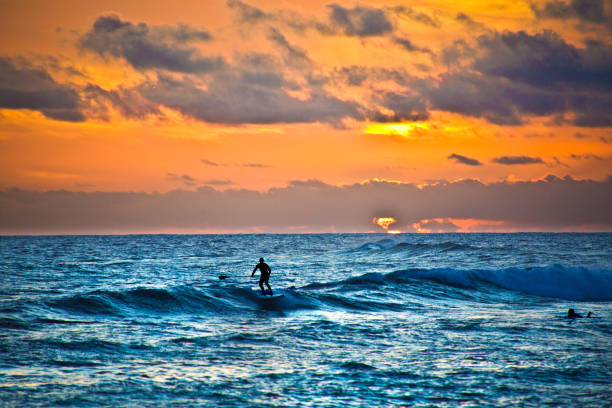 istock Paddleboard Surfer at Sunset, Poipu Beach, Kauai,Hawaii 911855374