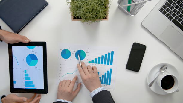 istock Businessmen Analising Diagrams 911858518