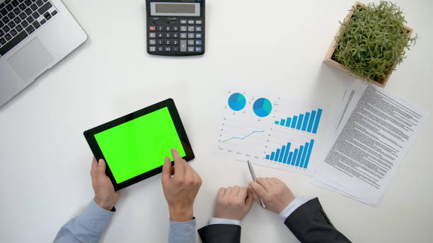 istock Businessmen Analising Diagrams 911858668