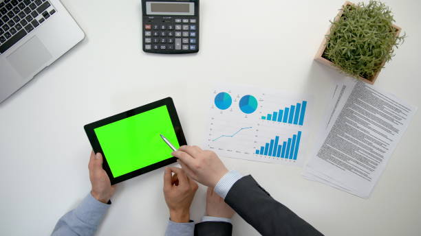 istock Businessmen Analising Diagrams 911858674