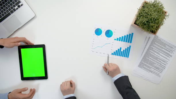 istock Businessmen Analising Diagrams 911858682