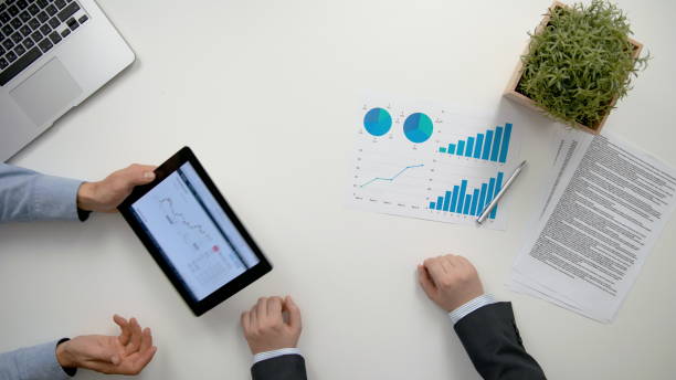istock Businessmen Analising Diagrams 911858698