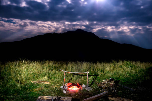 istock Campfire near mountain at night 911863080