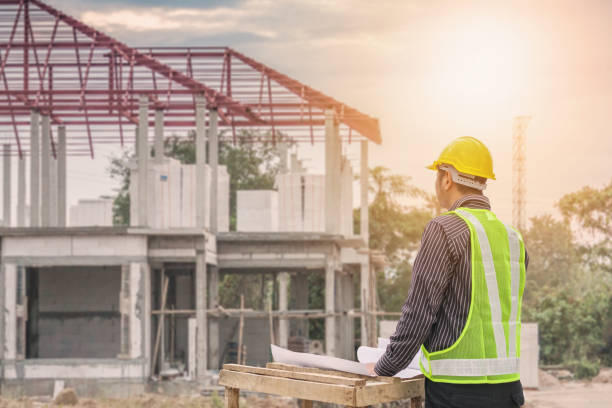 istock Asian business man construction engineer worker at house building site 911863968