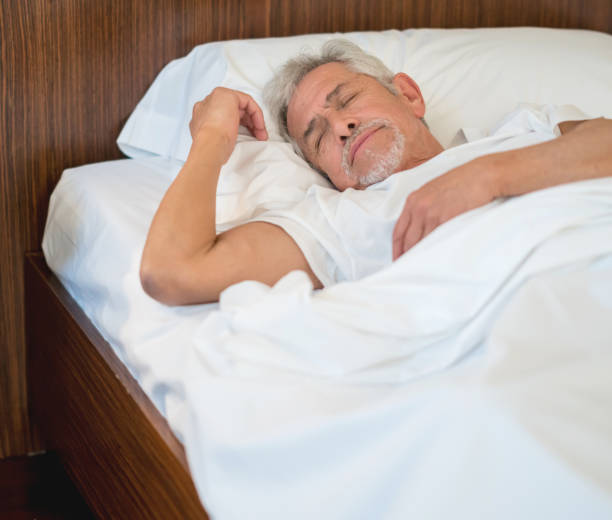 istock Serene senior man sleeping very comfortable in his bed 911864022
