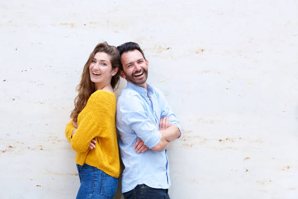istock Attractive couple leaning back to back with arms crossed 911865024