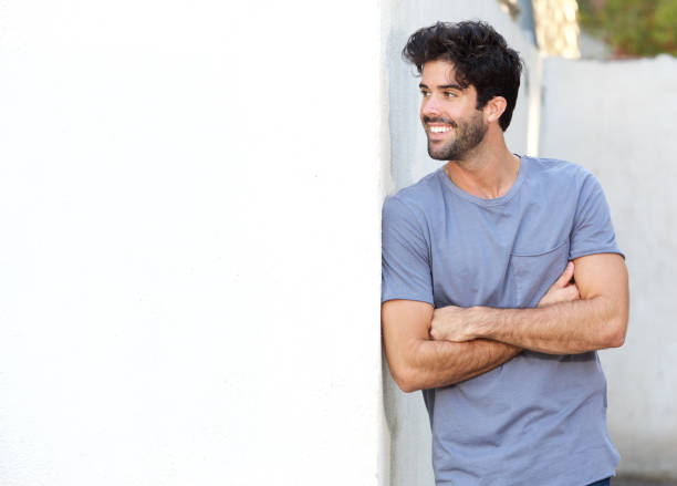 istock Confident handsome man standing with arms crossed outside 911865140