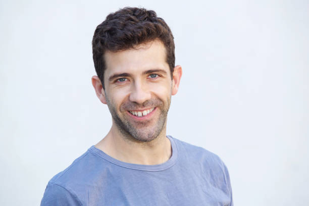 istock Close up confident young man smiling against white background 911867352