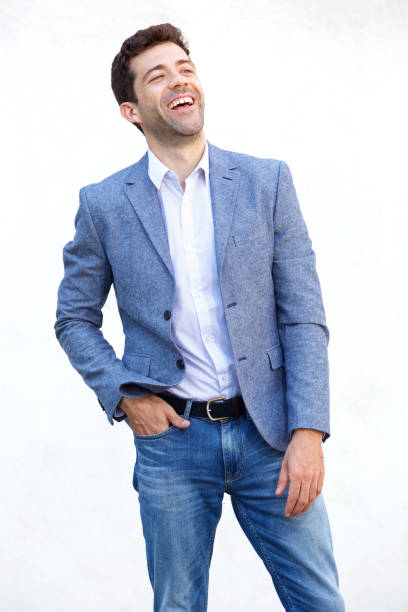 istock Handsome young man looking up and smiling against white background 911867358