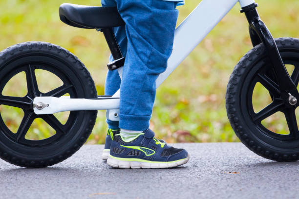 istock Active kid boy driving balance bicycle 911870974