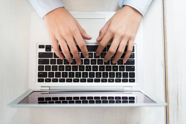 istock Woman hands typing on laptop computer close-up 911876348