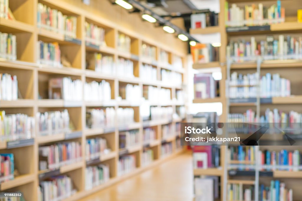 blur library blurred bookshelf in library room for your background design Library Stock Photo