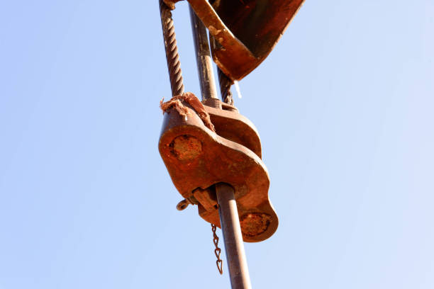 istock old rusty oil derrick in sunlight with blue sky 911888584