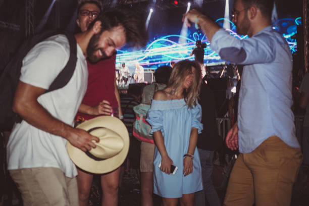 istock People dancing on festival and drinking beer 911891688