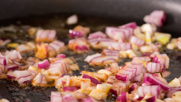 istock Frying red onion and garlic in pan 911891756