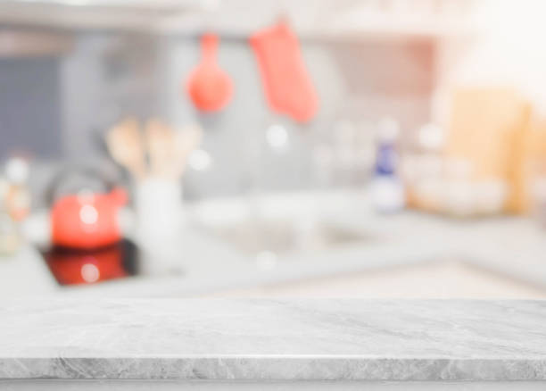 istock White stone table top and blurred kitchen interior background - can used for display or montage your products. 911901400