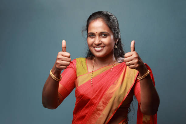 istock Traditionally dressed South Indian woman shows thumbs up 911901406