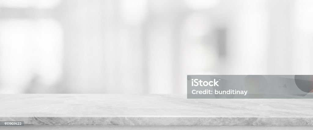 White stone marble table top and blurred abstract background from interior building banner background - can used for display or montage your products. Table Stock Photo