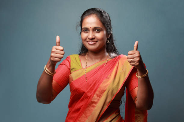istock Traditionally dressed South Indian woman shows thumbs up 911901442