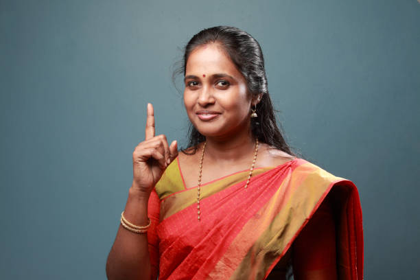 Traditionally dressed South Indian woman with pointing finger