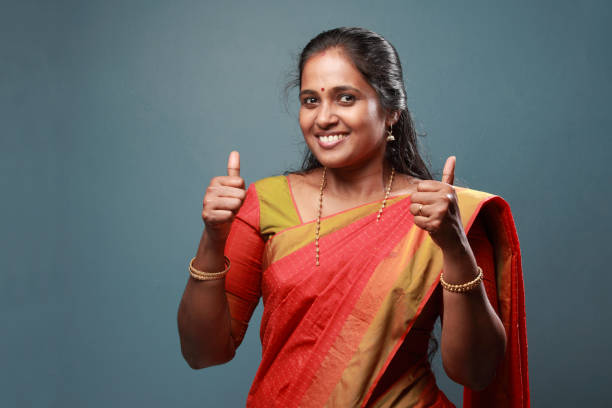 istock Traditionally dressed South Indian woman shows thumbs up 911901694