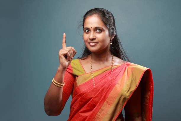 istock Traditionally dressed South Indian woman with pointing finger 911901698