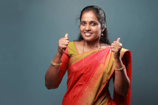 istock Traditionally dressed South Indian woman shows thumbs up 911901728