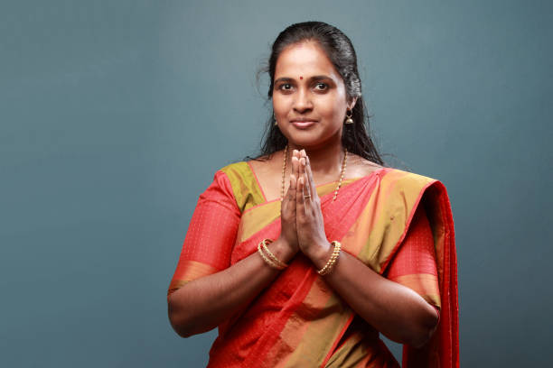 istock Traditionally dressed South Indian woman salutes with folded hands 911902926