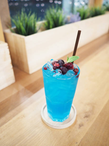 istock glass of blue cocktail with berries fruit 911904480